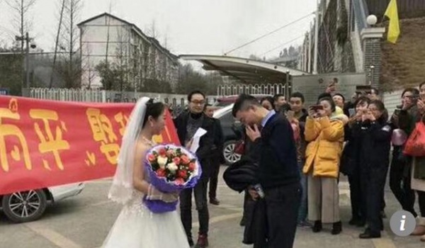 Cô gái mặc váy cưới cầu hôn bạn trai bên ngoài nhà tù